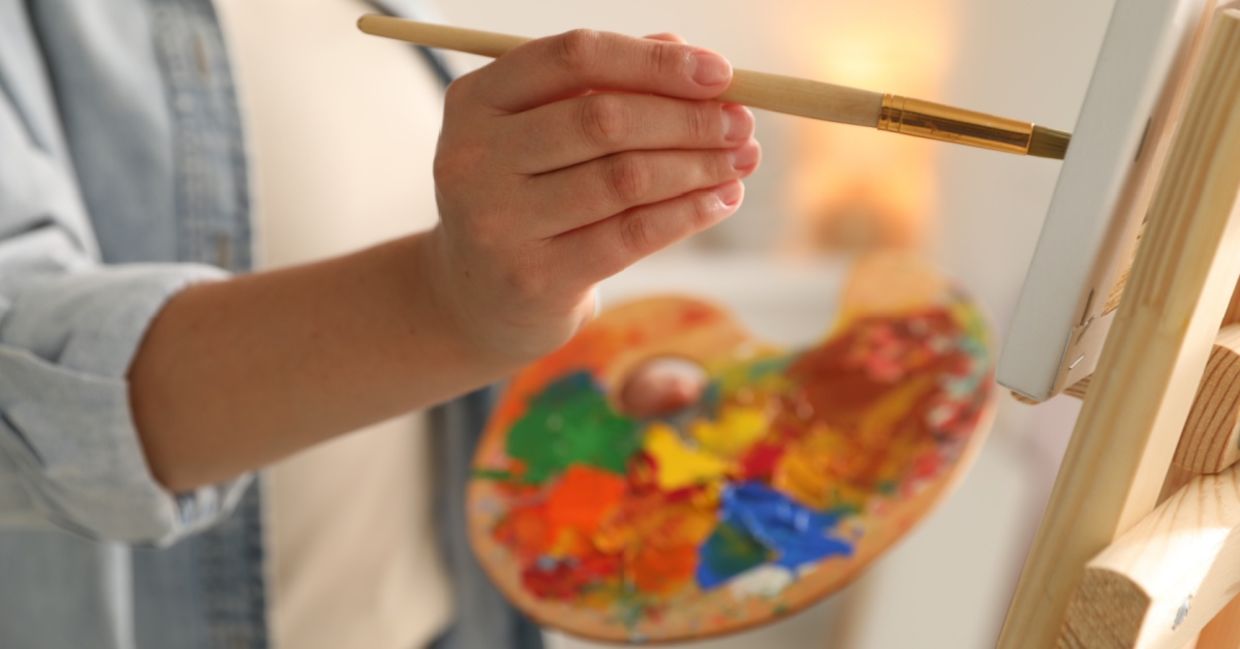 An artist painting a canvas.