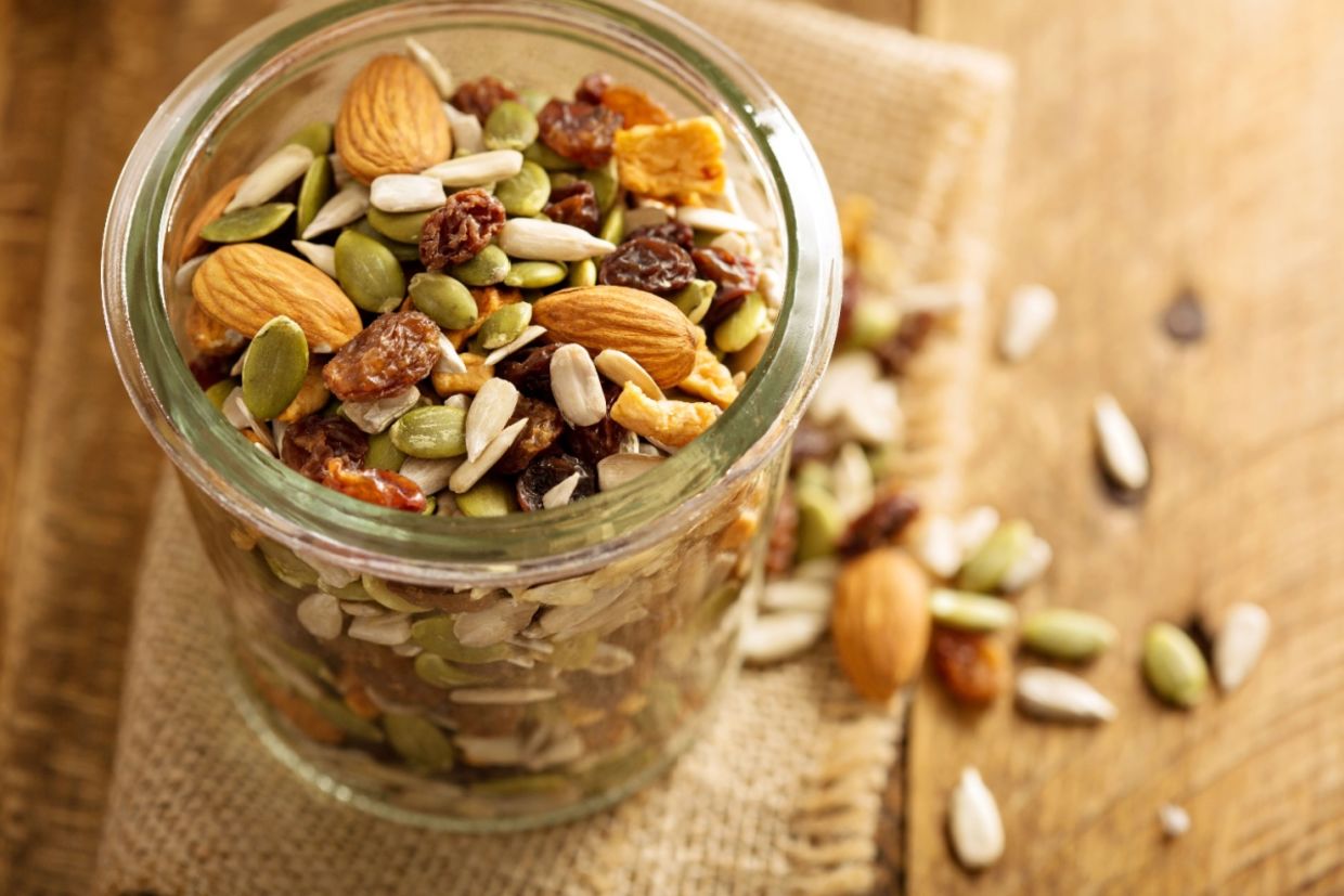 A jar filled with seeds and nuts.