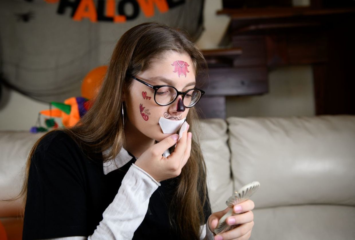 Applying scary Halloween tattoos.