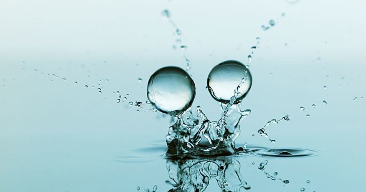 Gel balls falling against a blue background.