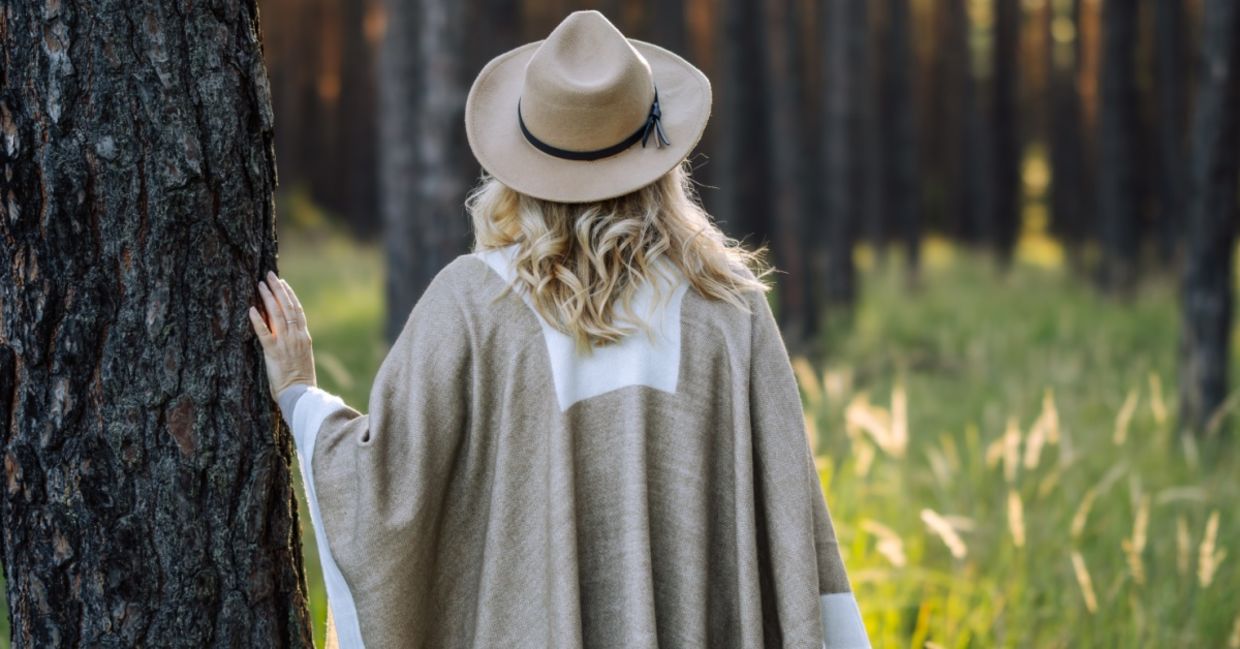 Woman contemplating the stillness of the forest.