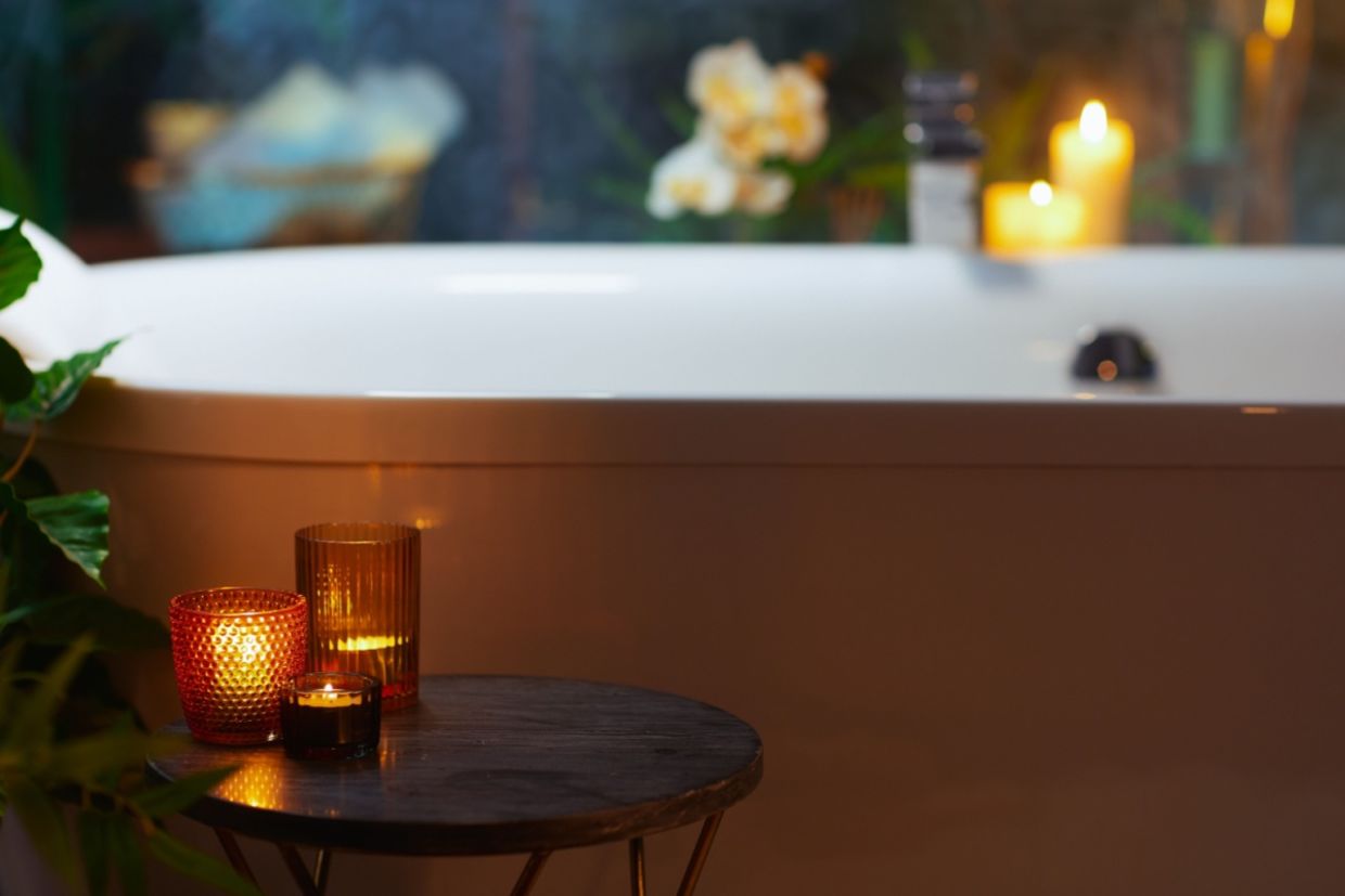 A bathroom with warm and dim candles.