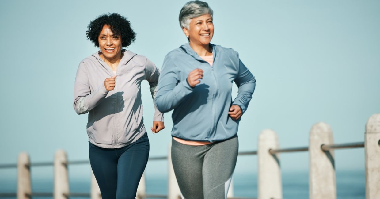 Senior women running on a boardwalk.