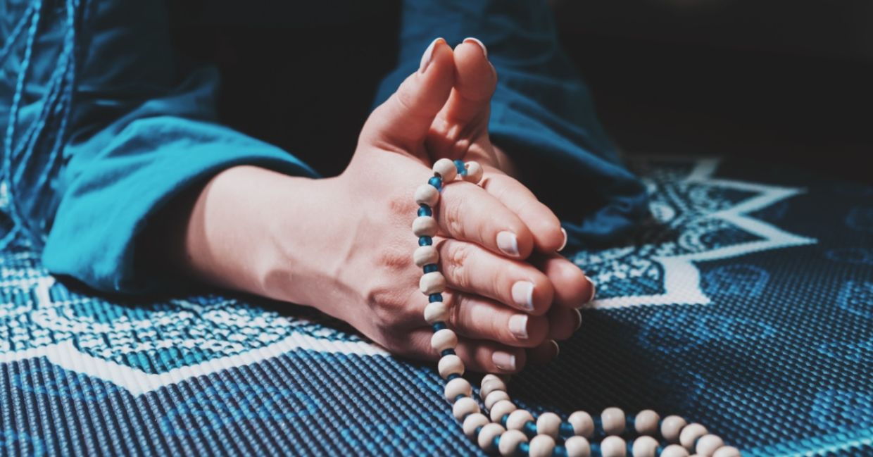 Woman meditating with a mala.