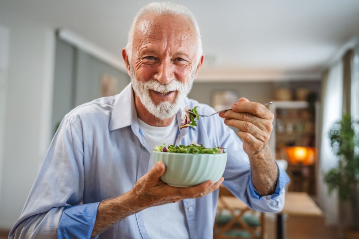 A man eats a salad.