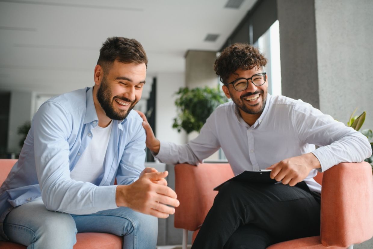 A therapist supports his patient.