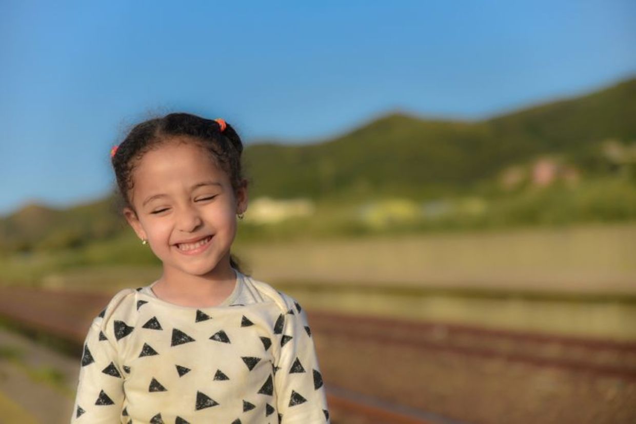 An Arab girl smiles sweetly.