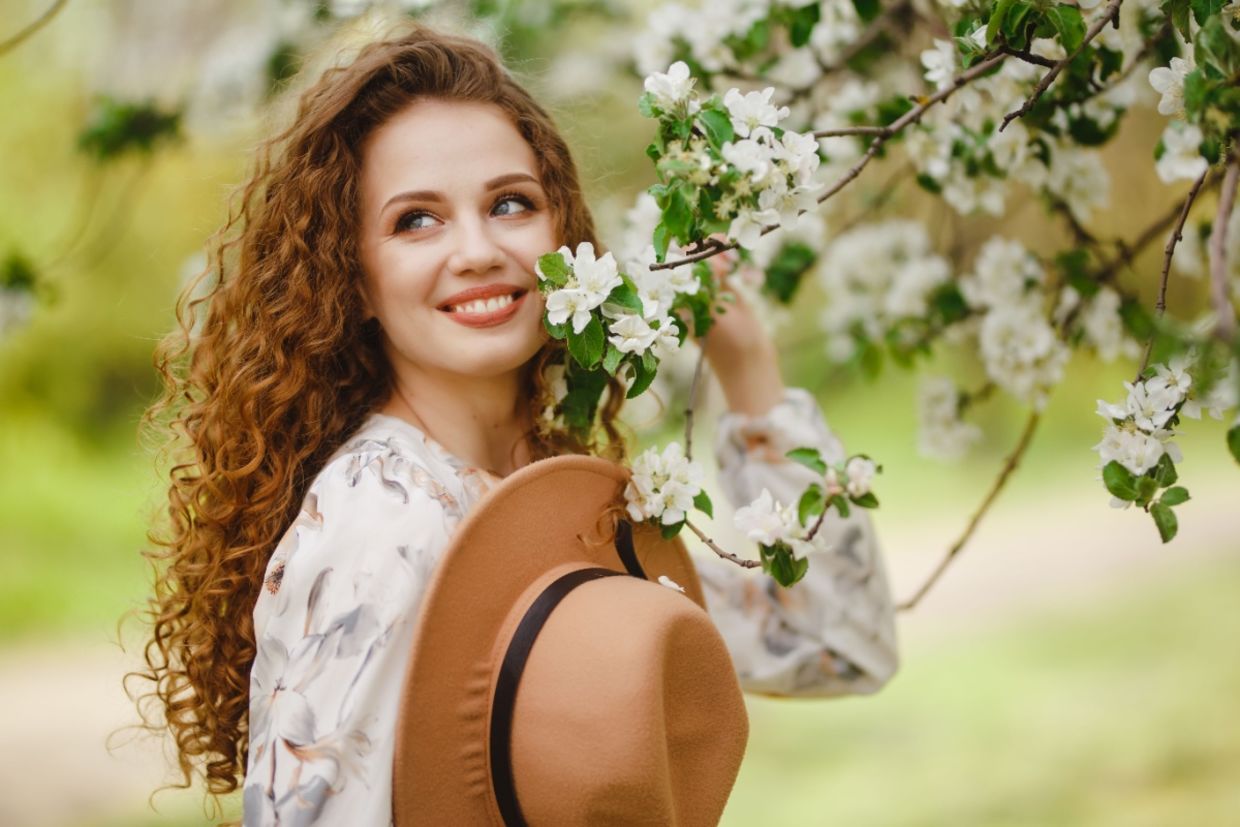 A woman in a blooming garden.