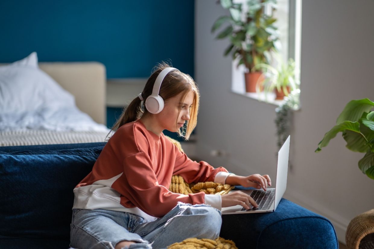 A teen focused on an online lesson.