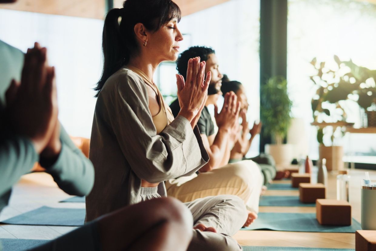 People relaxing in a yoga class.